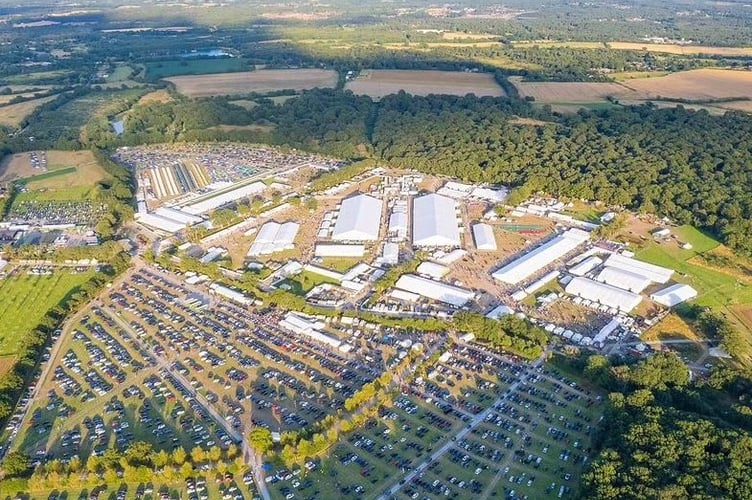 Drone image of the Jalsa Salana Site 2024.  White marquees and car parks fill the field. Jalsa Salana is the Annual Convention of the Ahmadiyya Muslim Community United Kingdom is a unique event that brings over 35,000 participants from more than 90 countries to in- crease religious knowledge and promote a sense of peace in society