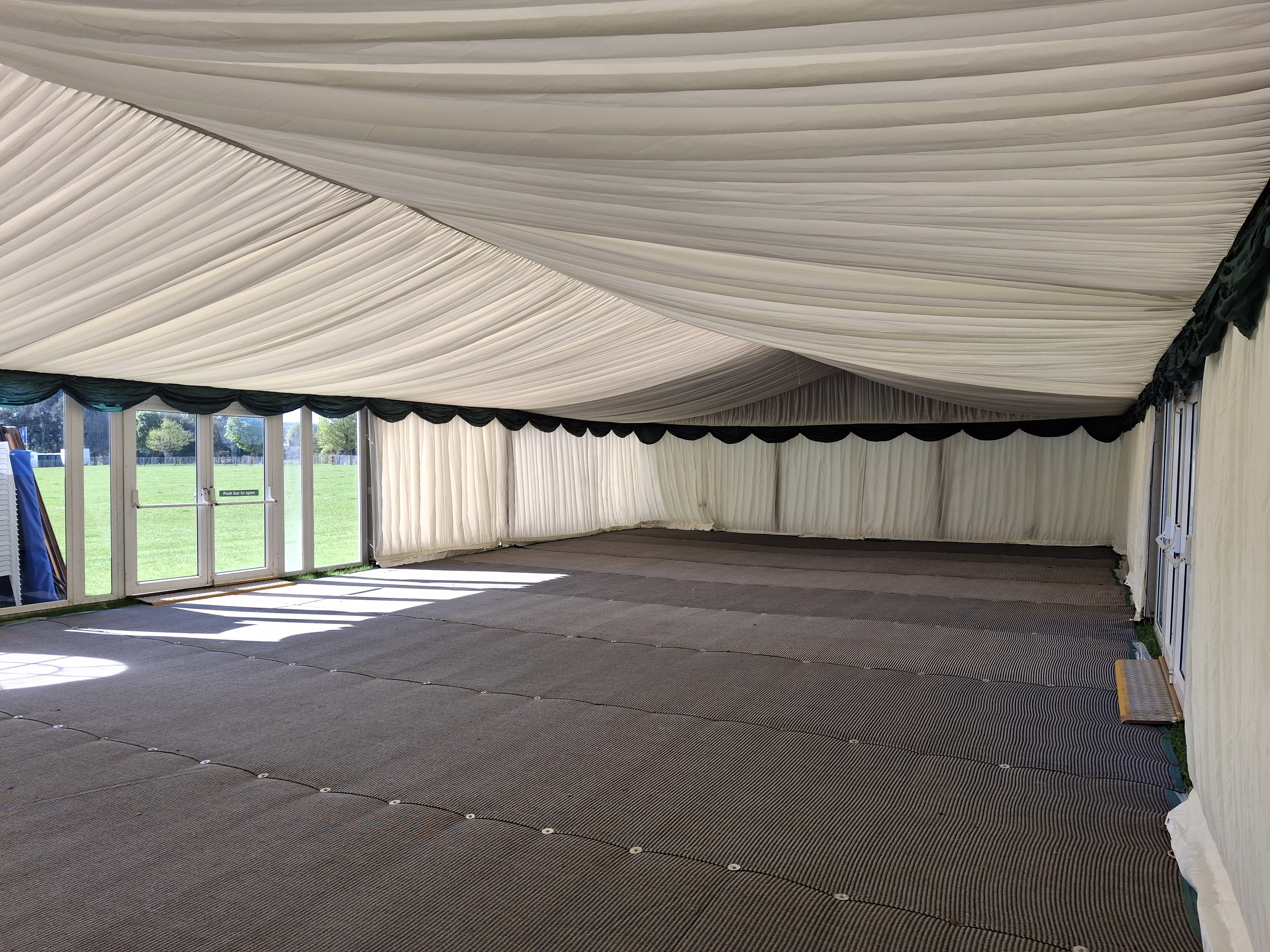 9m wide Marquee with Ivory Pleated Linings and Matting to the floor