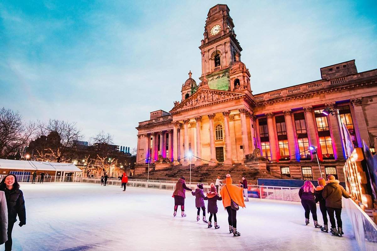 Skaters enjoying the real Ice Rink set in front of the beautiful Portsmouth Guildhall in the city centre of Portsmouth