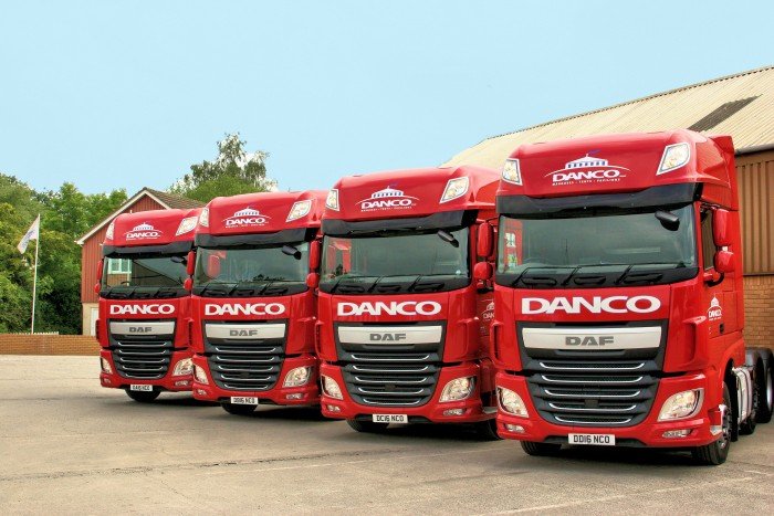 Four red Danco trucks at their HQ in Bristol.