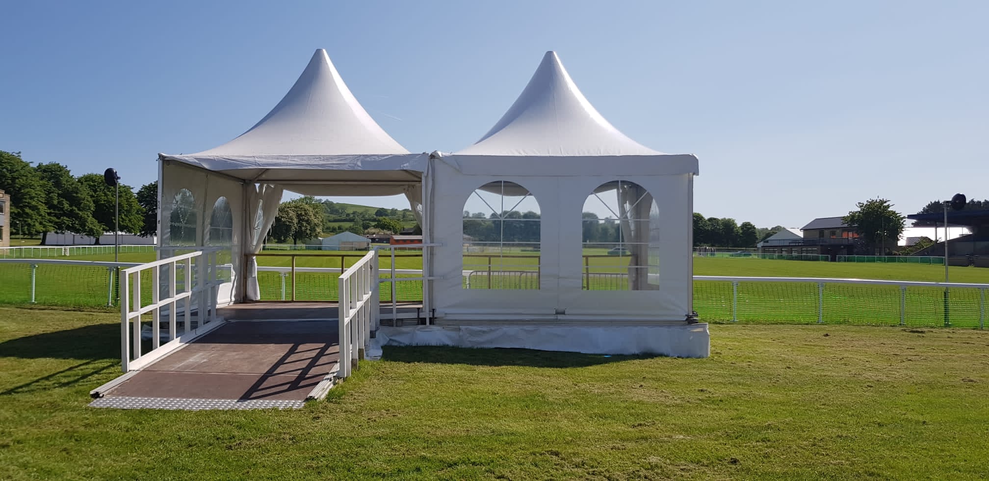 Two Danco marquee hats with accessible ramp leading up to the raised floor. 