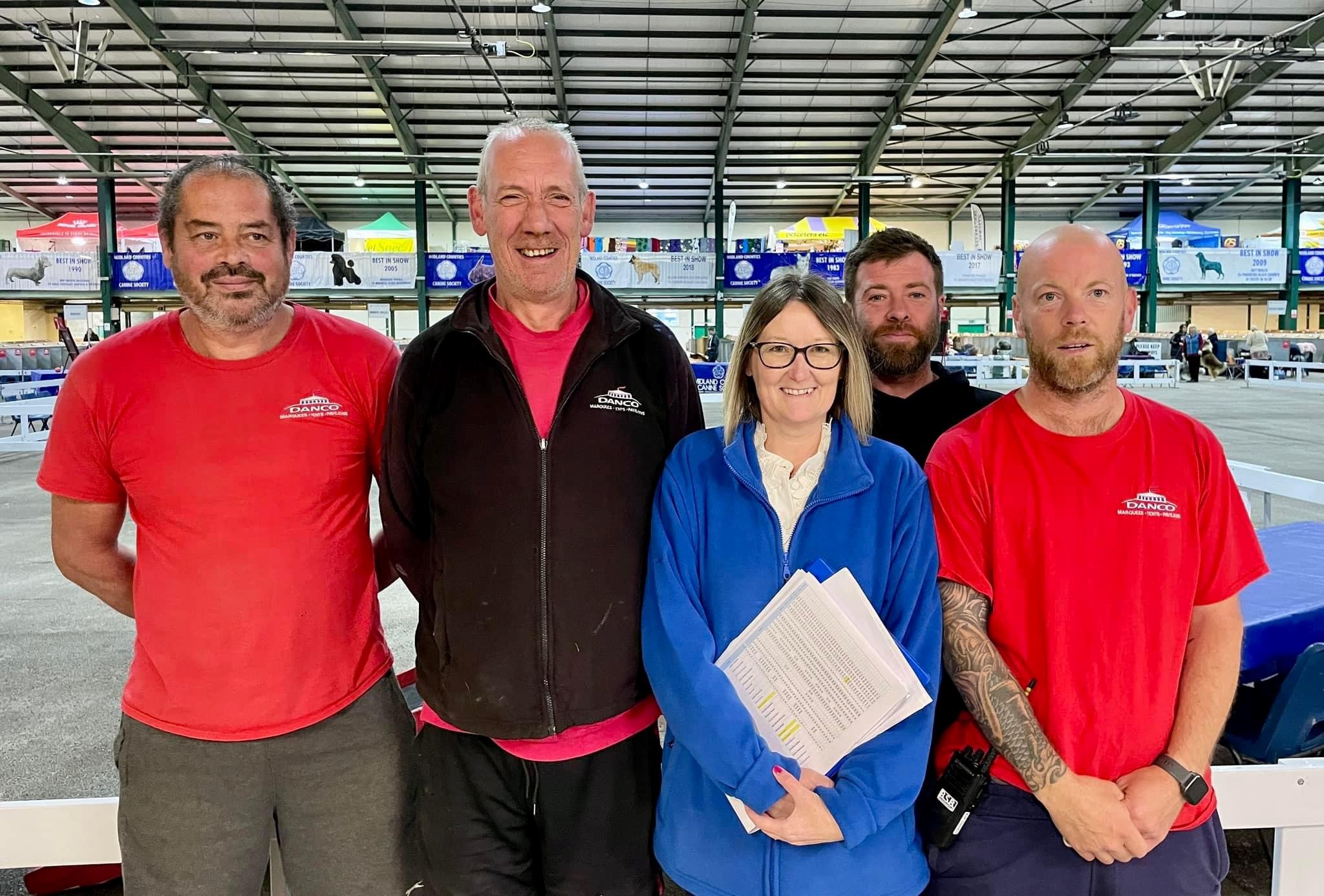 Danco marquee staff pose for a photo with client at a show