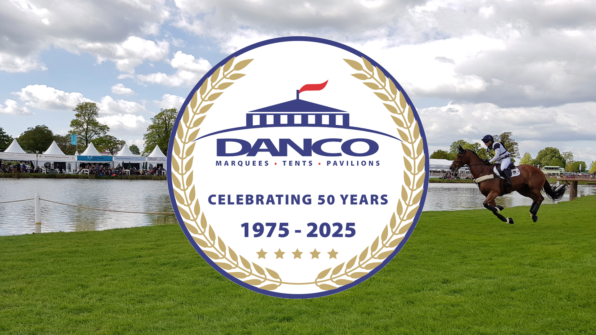 Danco 50 year logo displayed on Badminton Horse Trial course with a rider and horse competing in the background. 
